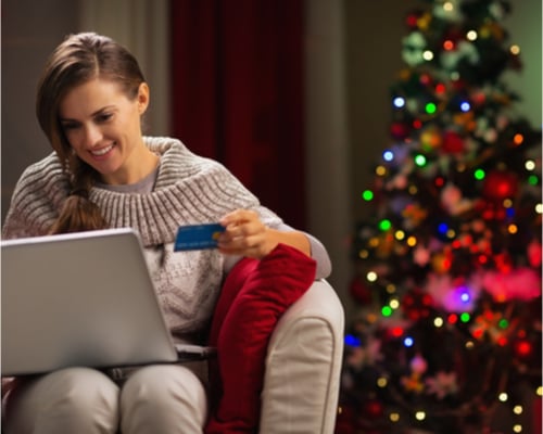 A woman ordering deliveries on a laptop at Christmas